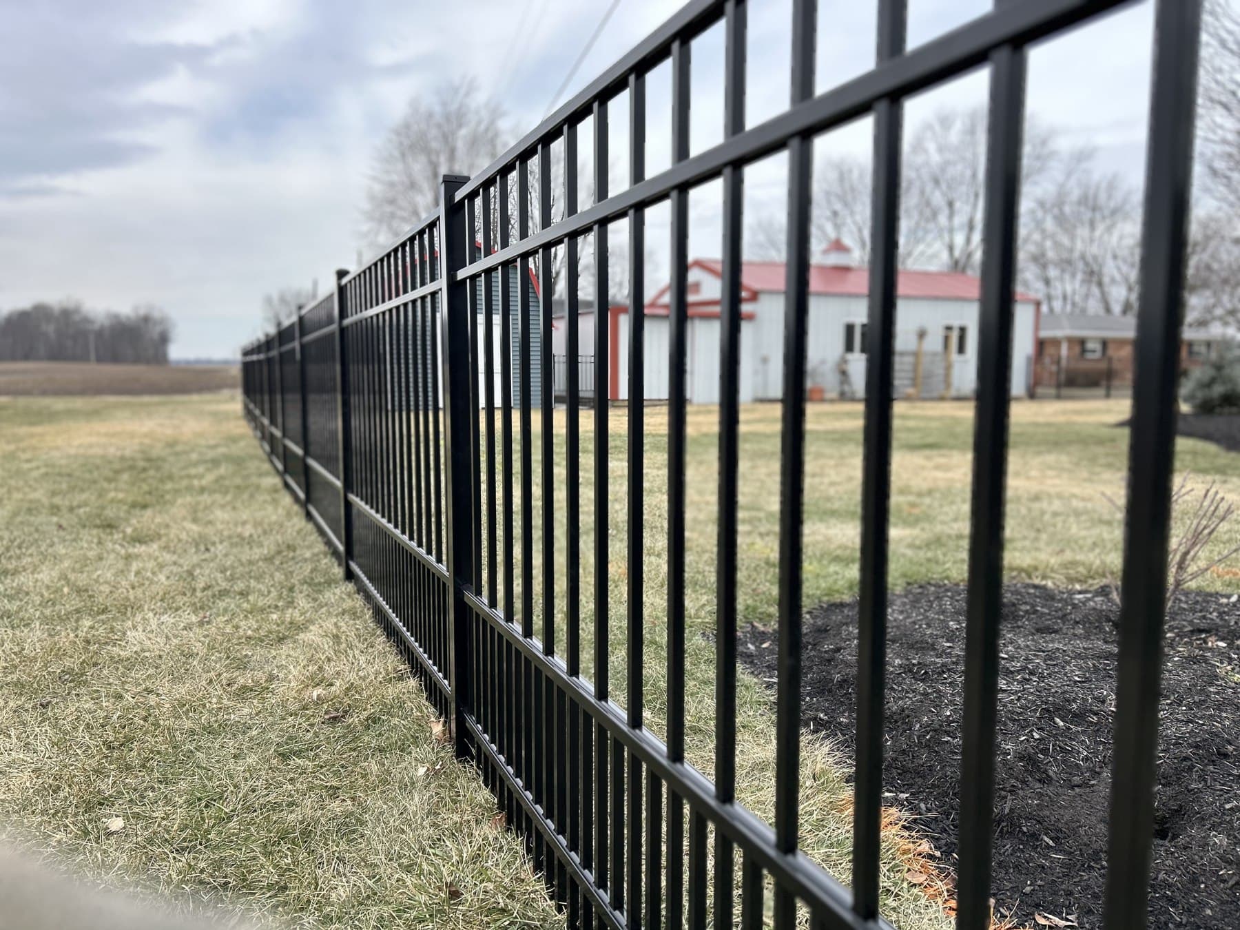 Black aluminum rails and pickets are shown from the side.