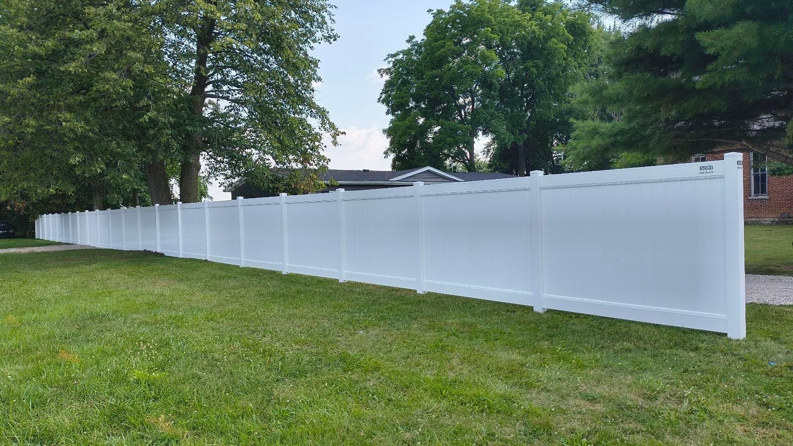 White privacy panels form a continuous boundary across the backyard.